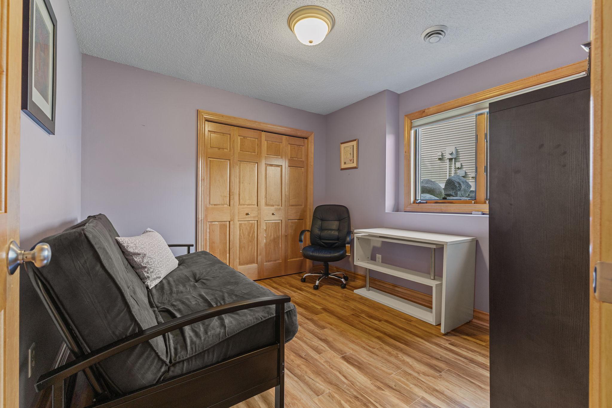 The fourth bedroom in the home located in the lower level showcases the solid 6 panel doors throughout the entire property.
