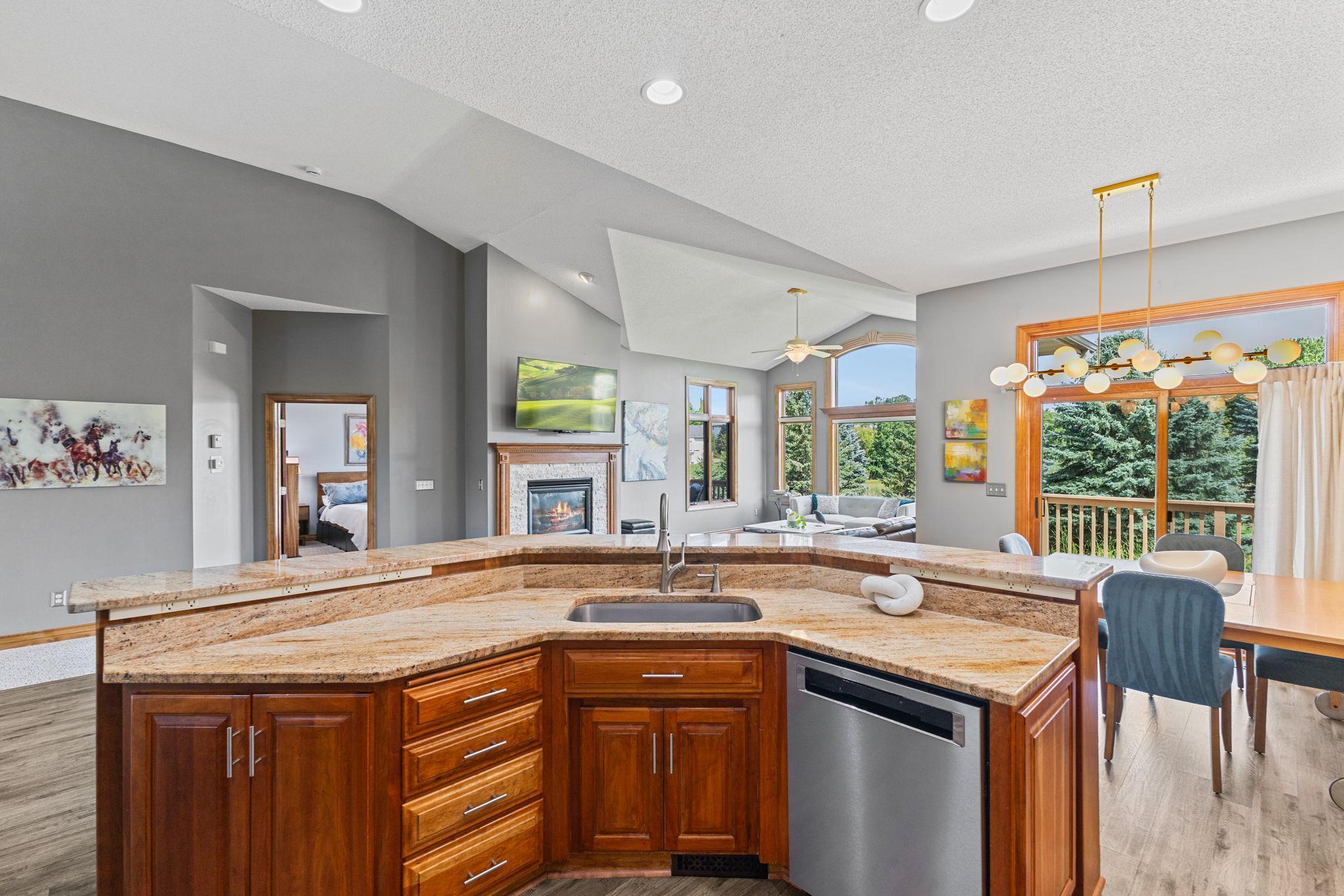 Main level kitchen adjacent to the dining area and primary living space! You will appreciate the generous granite counter space with the sink facing outward keeping you connected to the living and dining areas.