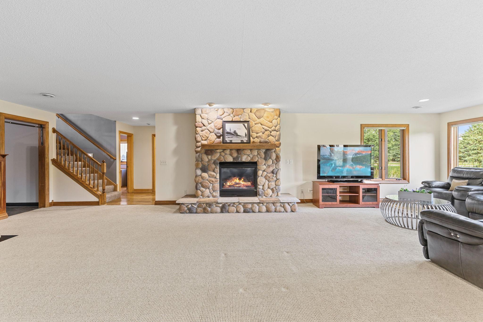 Wide open with an amazing focal point! This stone surround gas fireplace & hearth provides that grand lodge feel.