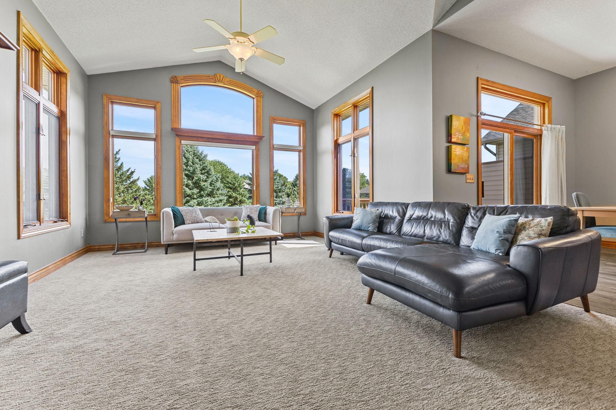 Expansive windows create a grand feel to the main level living room.