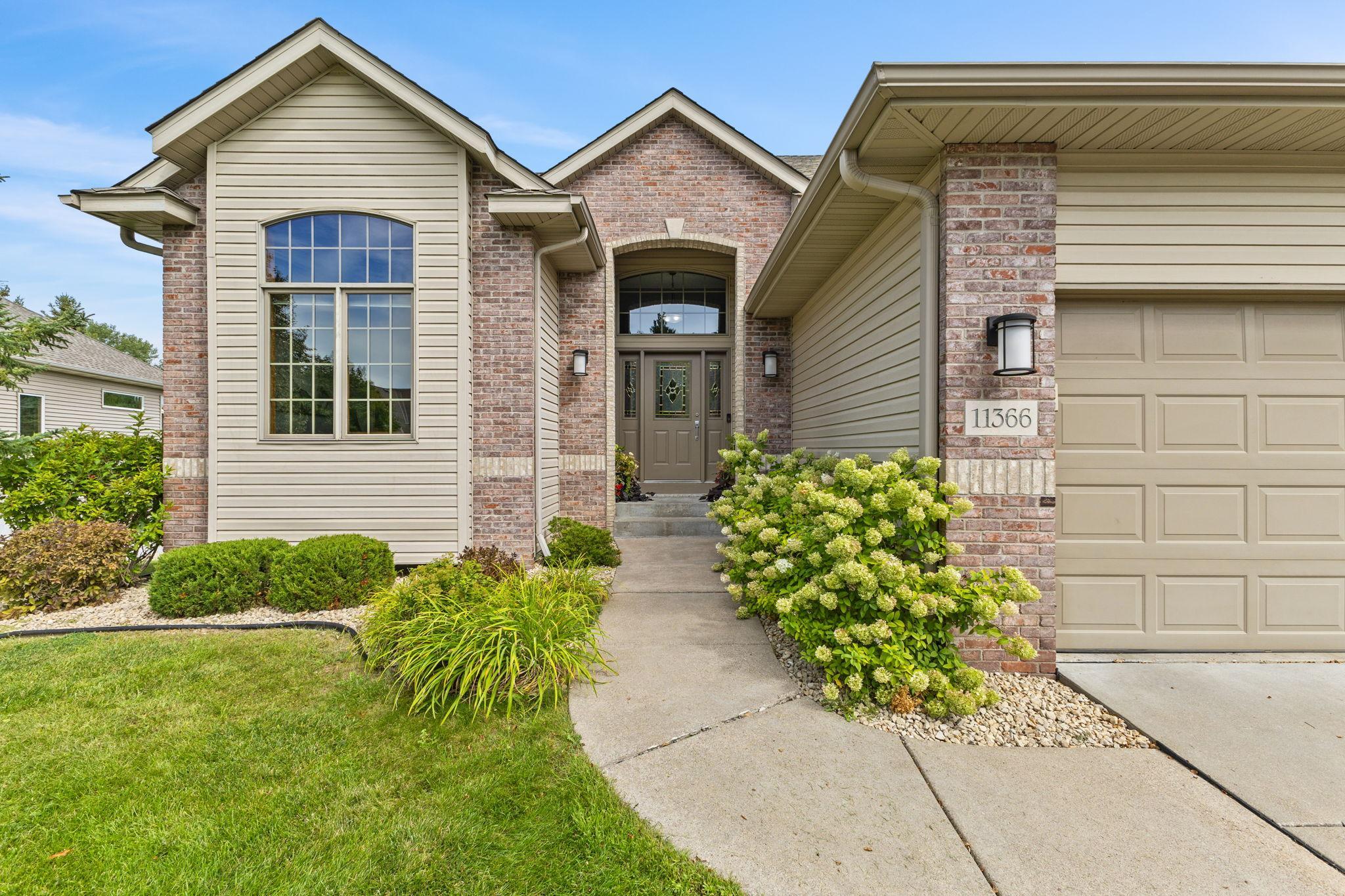 This custom built home features a timeless brick front, architectural details, covered front porch, gutters, new exterior light fixtures and a brand new roof!