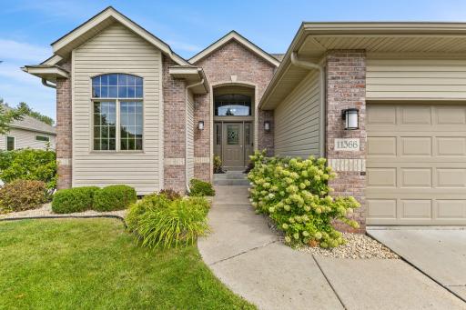 This custom built home features a timeless brick front, architectural details, covered front porch, gutters, new exterior light fixtures and a brand new roof!