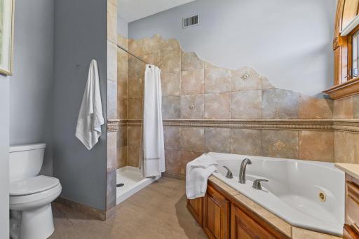 The separate custom artistically tiled shower creates a spa like ambiance.
