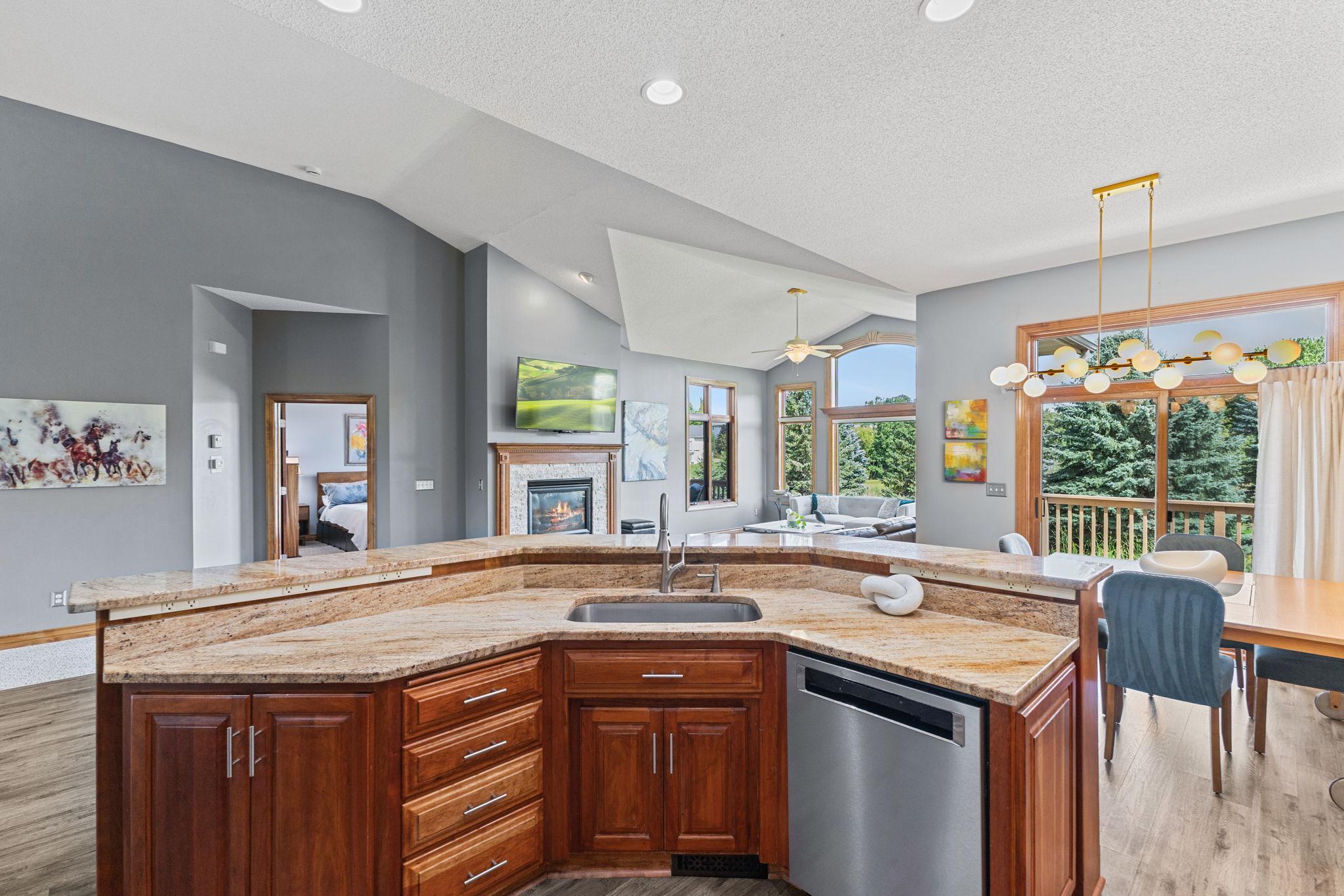 You will appreciate the generous granite counter space with the sink facing outward keeping you connected to the living and dining areas.