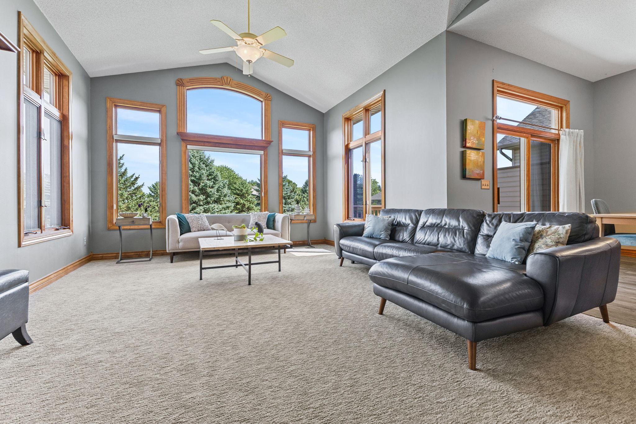Expansive windows create a grand feel to the main level living room.