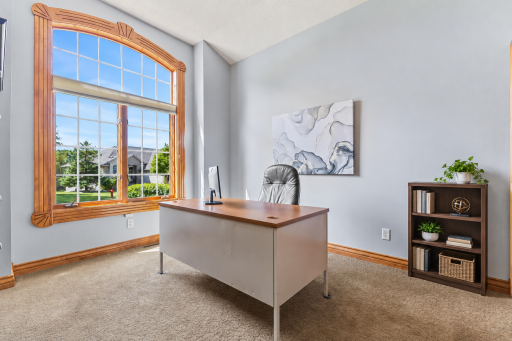 Adjacent to the entryway, this room could be used as a second bedroom on the main level or ideal home office. The oversized window allows natural light to fill the room! 10' ceilings, neutral carpet and professionally painted walls are a big bonus.