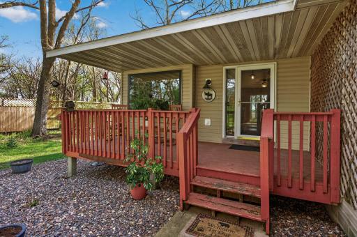 Relax and enjoy the wooded acreage on your front porch