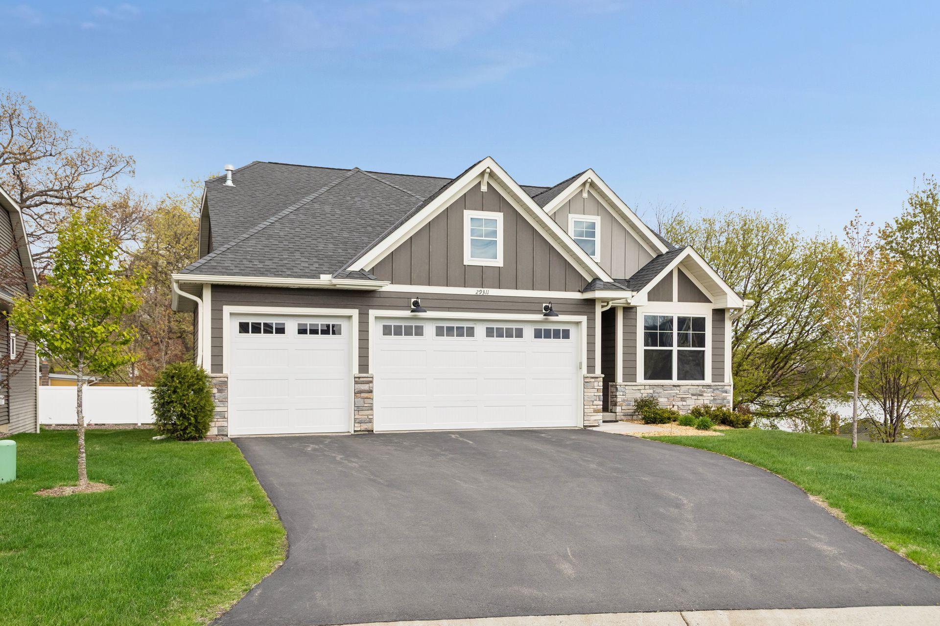 Nice wide driveway is ideal for guest parking. Note: Association dues cover lawn care, snow removal, irrigation and trash.