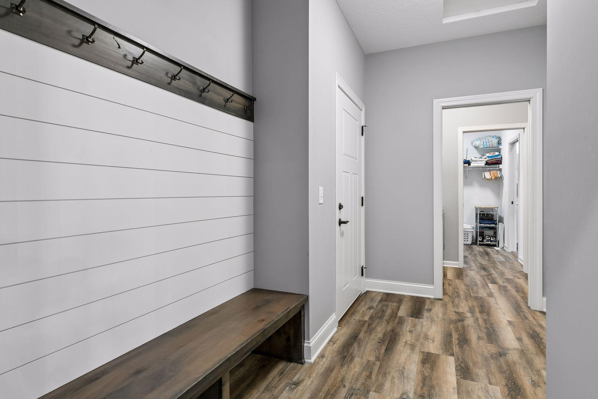 Large back Mudroom off the 3 car garage. Lot of coat hanging and comfort of a long built-in bench.