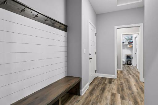 Large back Mudroom off the 3 car garage. Lot of coat hanging and comfort of a long built-in bench.