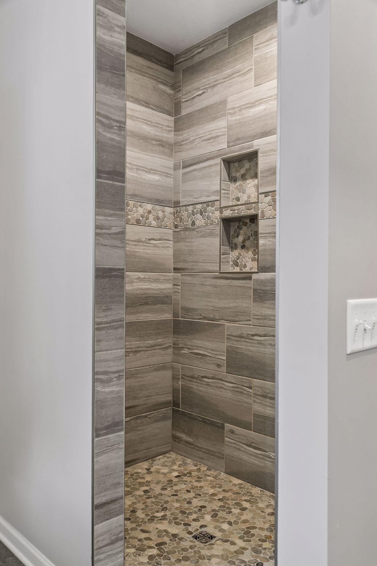 Fully tiled walk-in shower. 2 built-in niches and notice no shower door to clean!