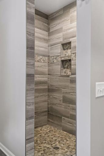 Fully tiled walk-in shower. 2 built-in niches and notice no shower door to clean!