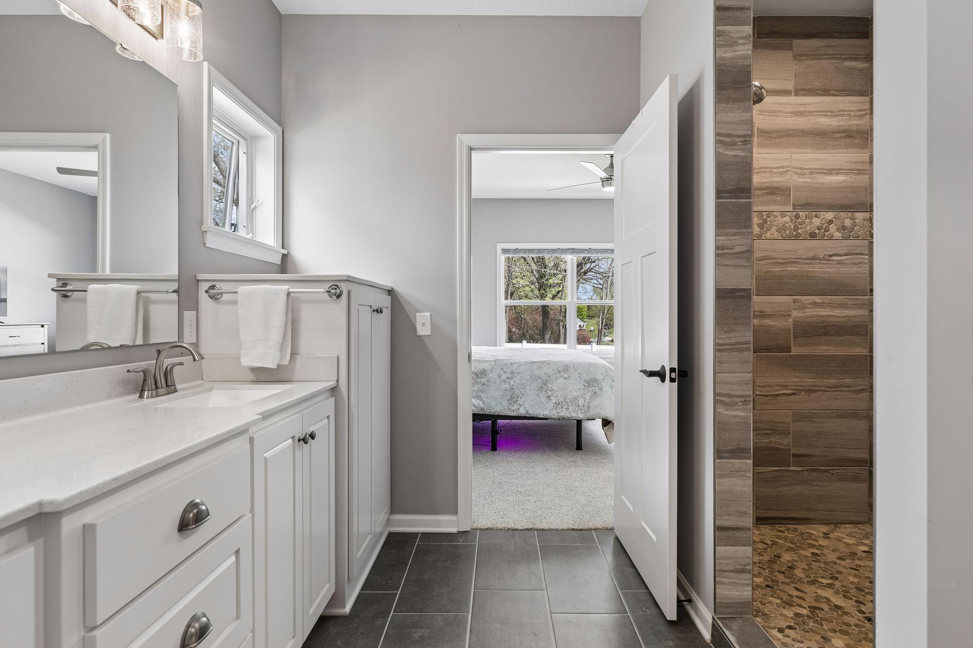 Primary Bath with double sink vanity and built-in linen cabinet.
