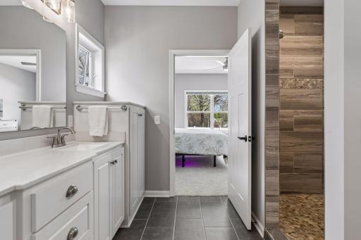 Primary Bath with double sink vanity and built-in linen cabinet.
