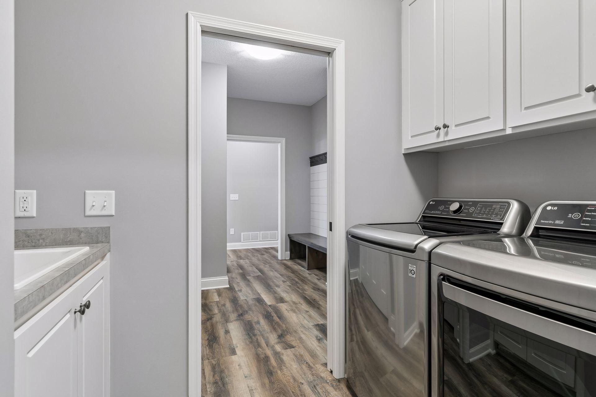 Laundry Room with built-in utility sink. Conveniently located off the Mudroom and Primary Bedroom Walk-In Closet.