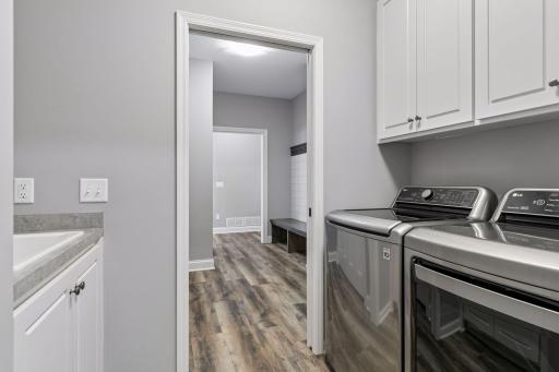 Laundry Room with built-in utility sink. Conveniently located off the Mudroom and Primary Bedroom Walk-In Closet.