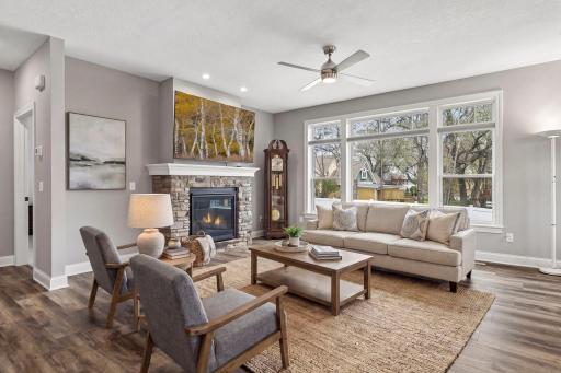 Main level living room with oversized window with transom above. (Virtual staged in this photo)