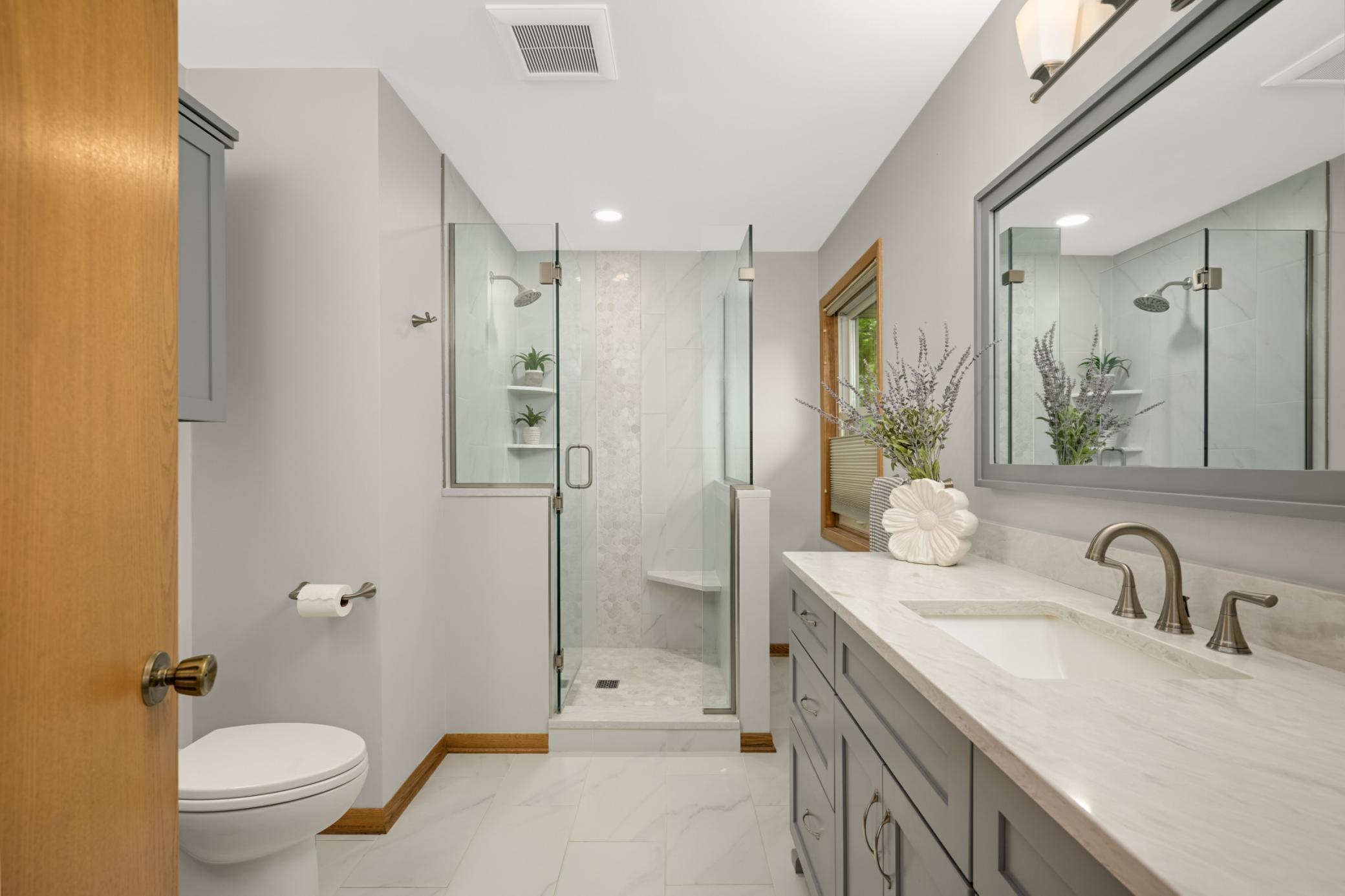 Two vanities and tiled walk-in shower.
