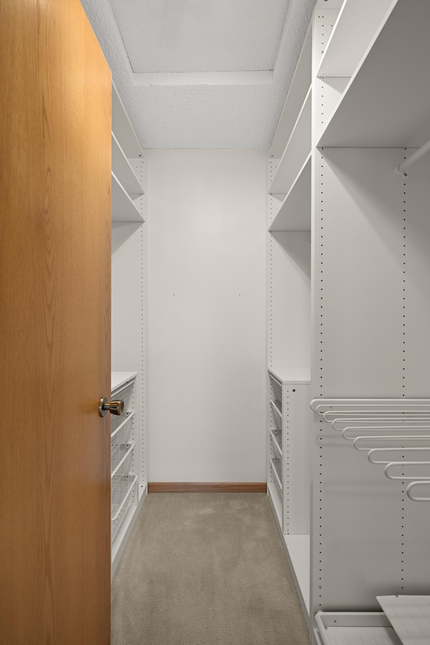 Walk-in closet with built-ins.
