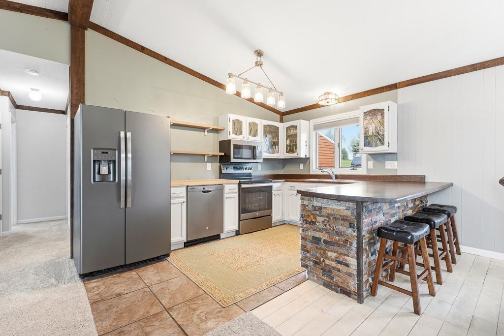 Updated stainless steel appliances, nicely located kitchen window, and a large island!