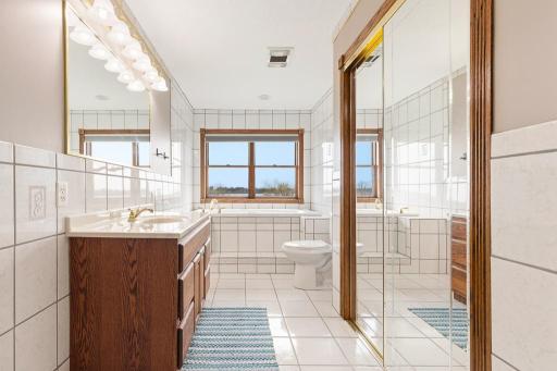 Upper level primary suite. AMAZING space! Tile floors, large tub, and extra closet space!
