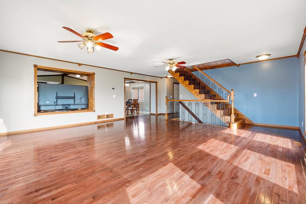 Large opening into the kitchen, dining, and second living room space.
