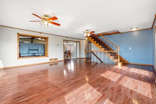 Large opening into the kitchen, dining, and second living room space.