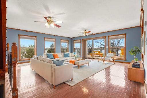 Stunning main floor living area features hardwood floors, wall to wall windows, and direct access to the new deck!