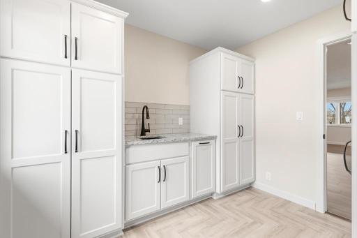 Hidden in the cabinets is a specific pull out for trash or even a laundry hamper!