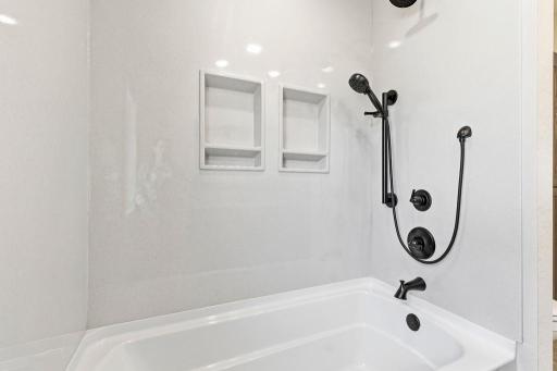 Beautiful full tub/shower with onyx surround.