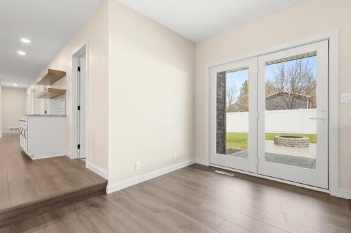 The patio door is nicely located between the kitchen and living room space creating a wonderful flow out to the stamped concrete patio space.