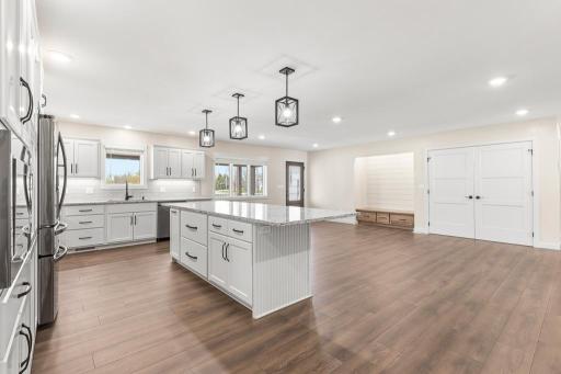 Quartz countertops with beautiful hues throughout the ample counter and cabinet space.