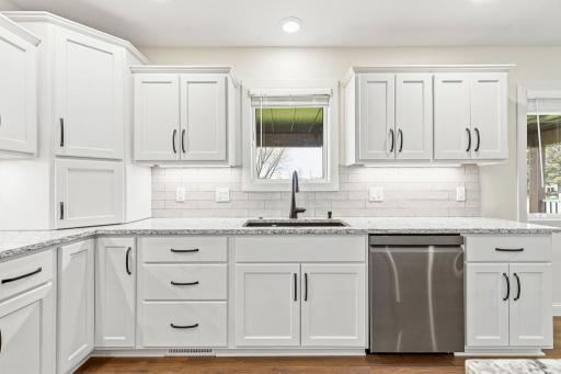 The kitchen window shows off a nice East facing view that overlooks green space and part of the nearby golf course!