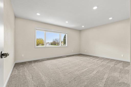 Main floor primary suite! East facing views that overlook green space and a portion of the golf course!