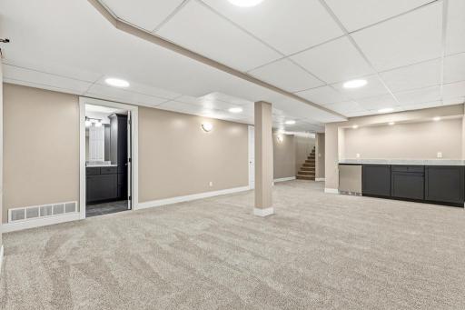 The lower level features two spacious family rooms, 2 bedrooms, a stunning 3/4 bath, a mini bar, 2 mechanical rooms, and an additional storage room!