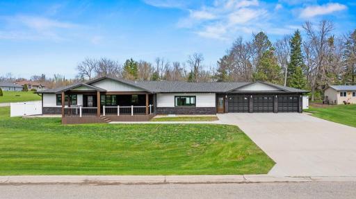 Large 3 stall garage, extended concrete drive, modern black sleek finishes, covered maintenance-free deck with soffit lighting and black rails, Certainteed Northgate shingles, and LP Smart siding!
