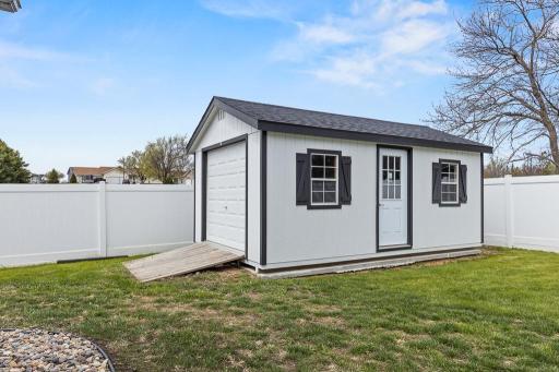 12x20 Dakota Storage Shed with Concrete Slab, overhead door, and exterior door access