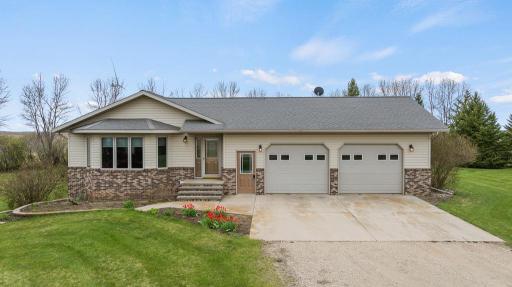 Steel siding, new roof, finished garage, and just under 2 acres off a black top road!