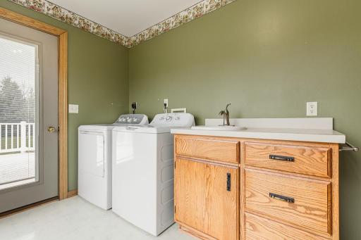 Main floor laundry also features a sink and great storage!
