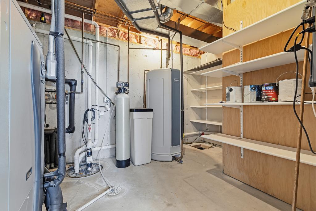 Utility room shows off the poured concrete foundation, owned water softener, marathon water heater, and GEOTHERMAL heat system which is only a few years old!