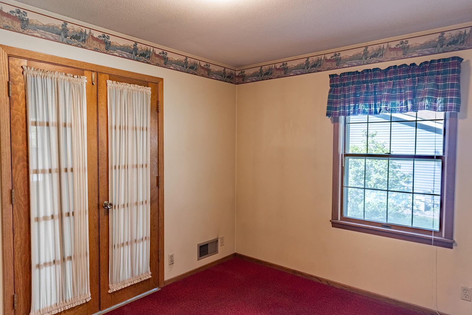 The French doors of this main-level Bedroom lead out to the Family Room