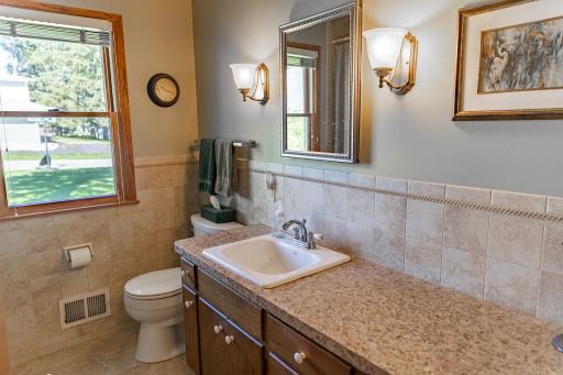 Updated main-level full Bath includes a ceramic tile shower