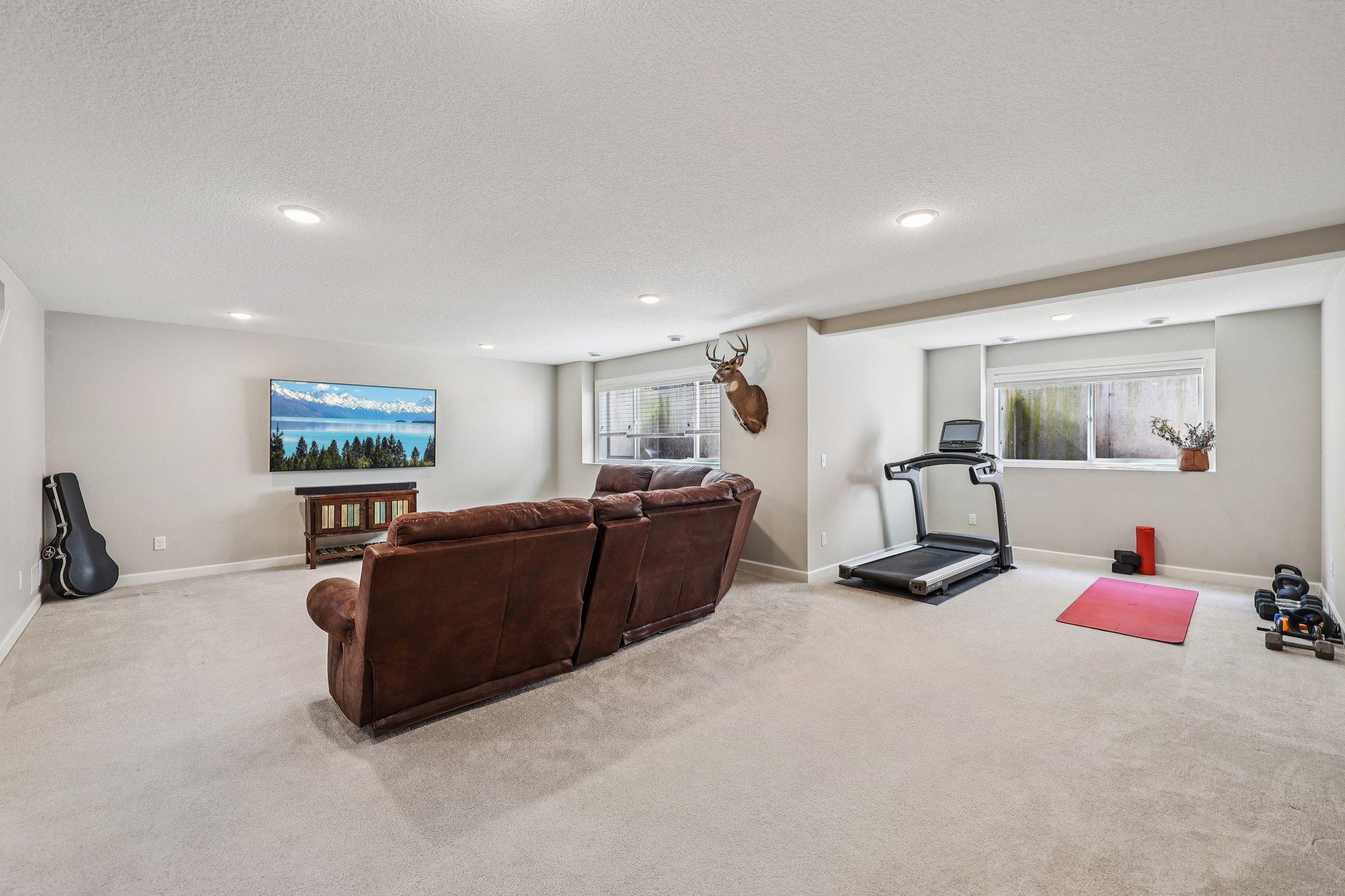 Finished lower level family room offering additional living space ideal for recreation, media area, or gatherings.