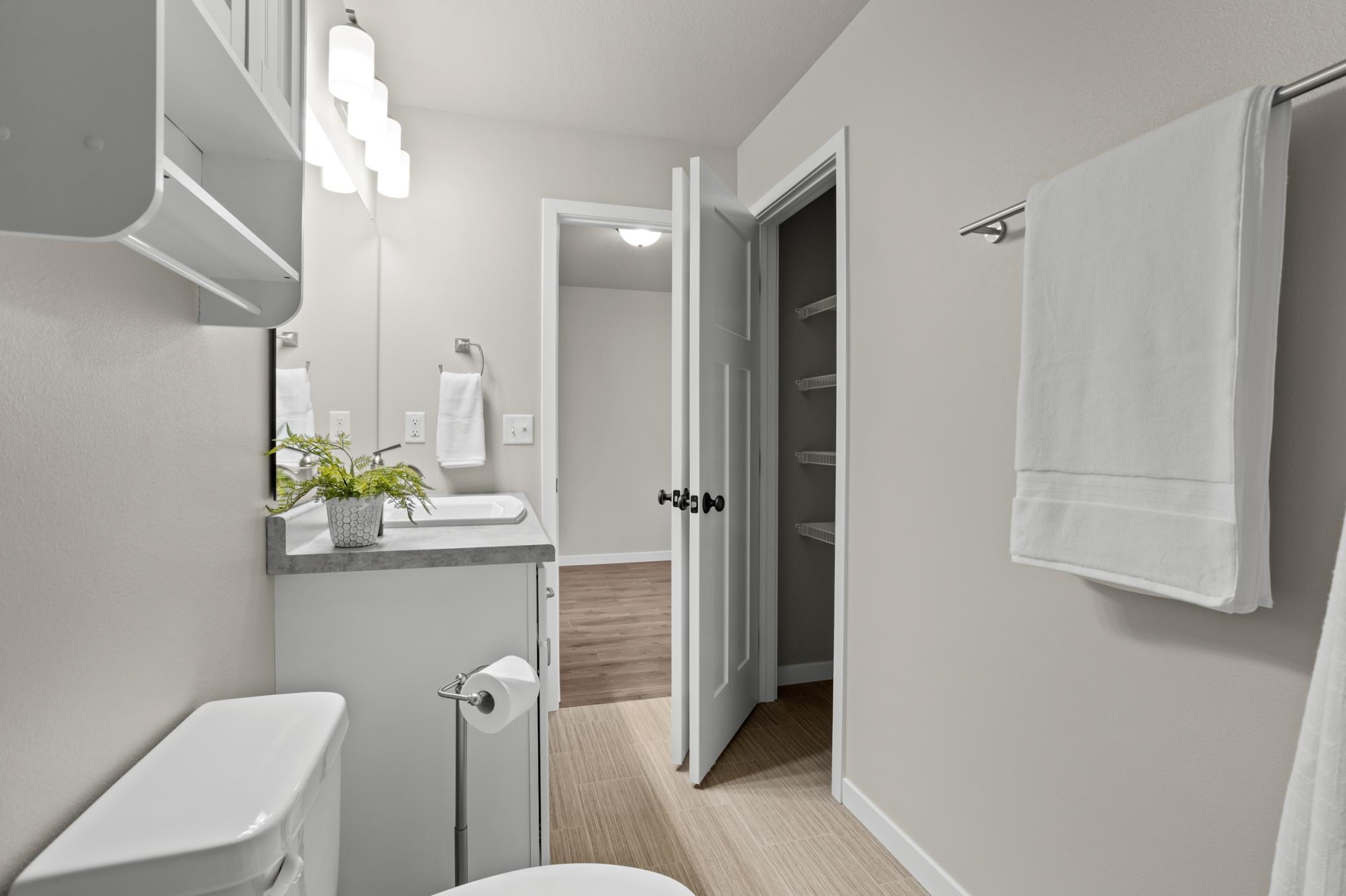 Main level full bathroom with linen closet