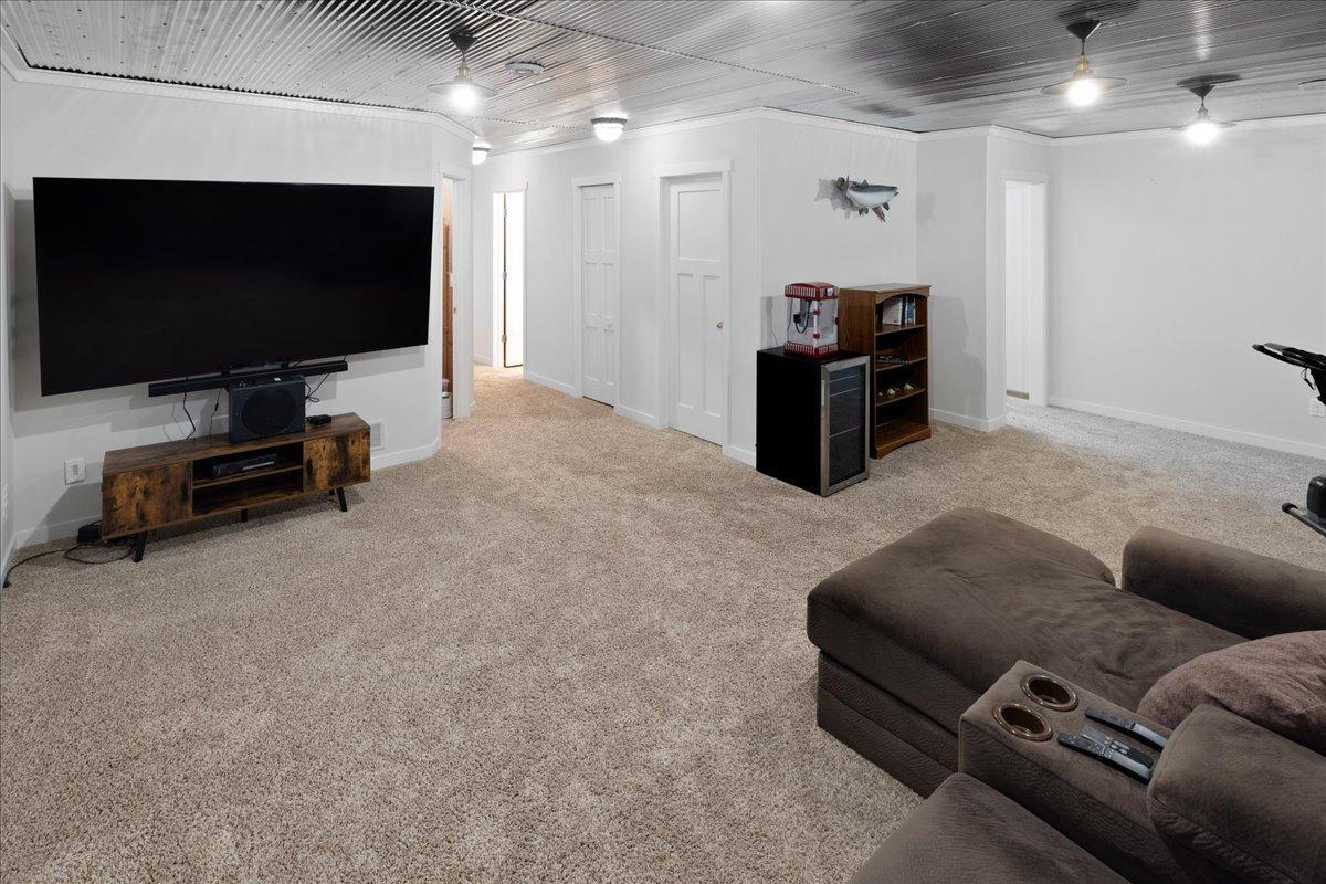 Spacious entertainment area in the lower level is accent with a metal ceiling. Note; there is lots of storage in the lower level too!