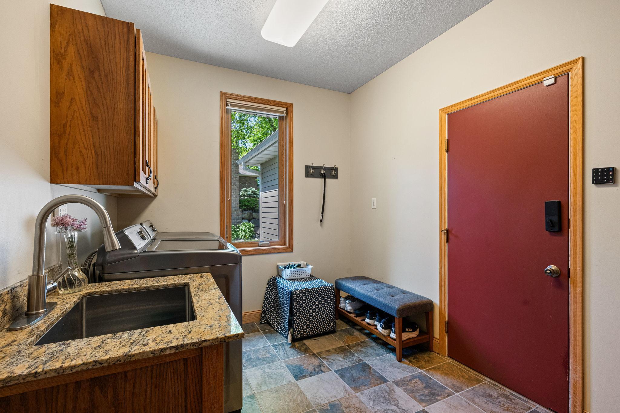 main floor laundry with closet and cabinets