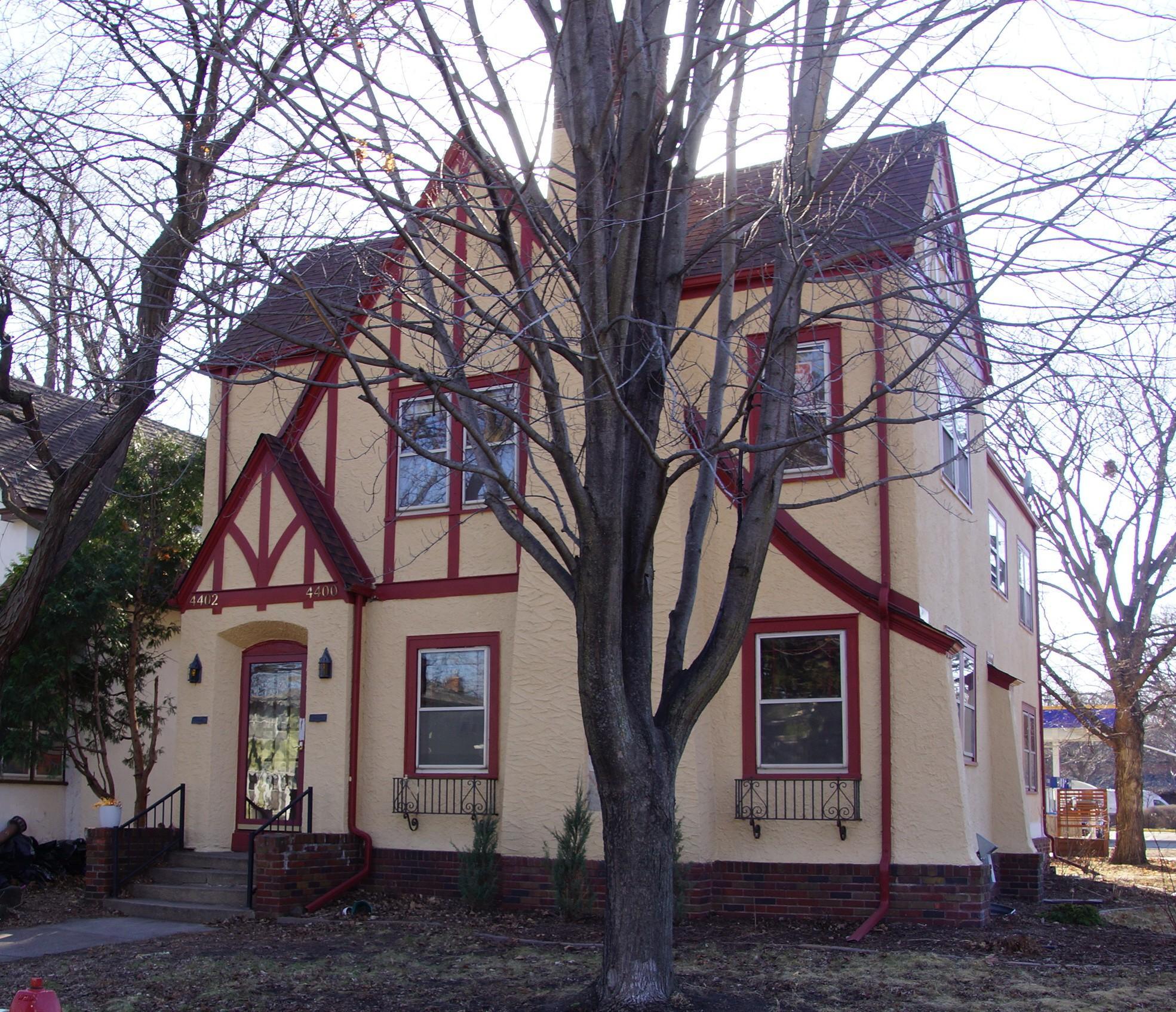 Classic Tudor Duplex. Front Entry leads to interior staircase and secure entry for both units.