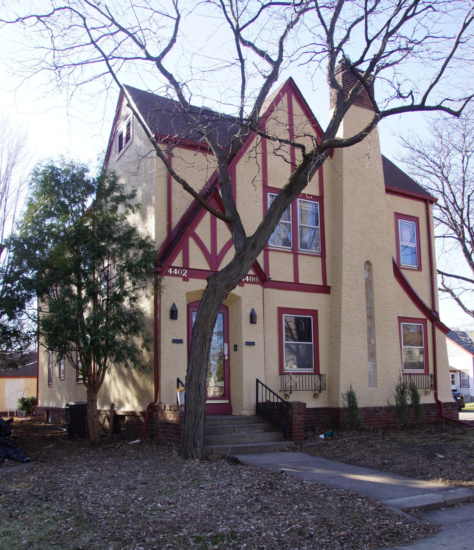 Classic Tudor Duplex. Front Entry leads to interior staircase and secure entry for both units.