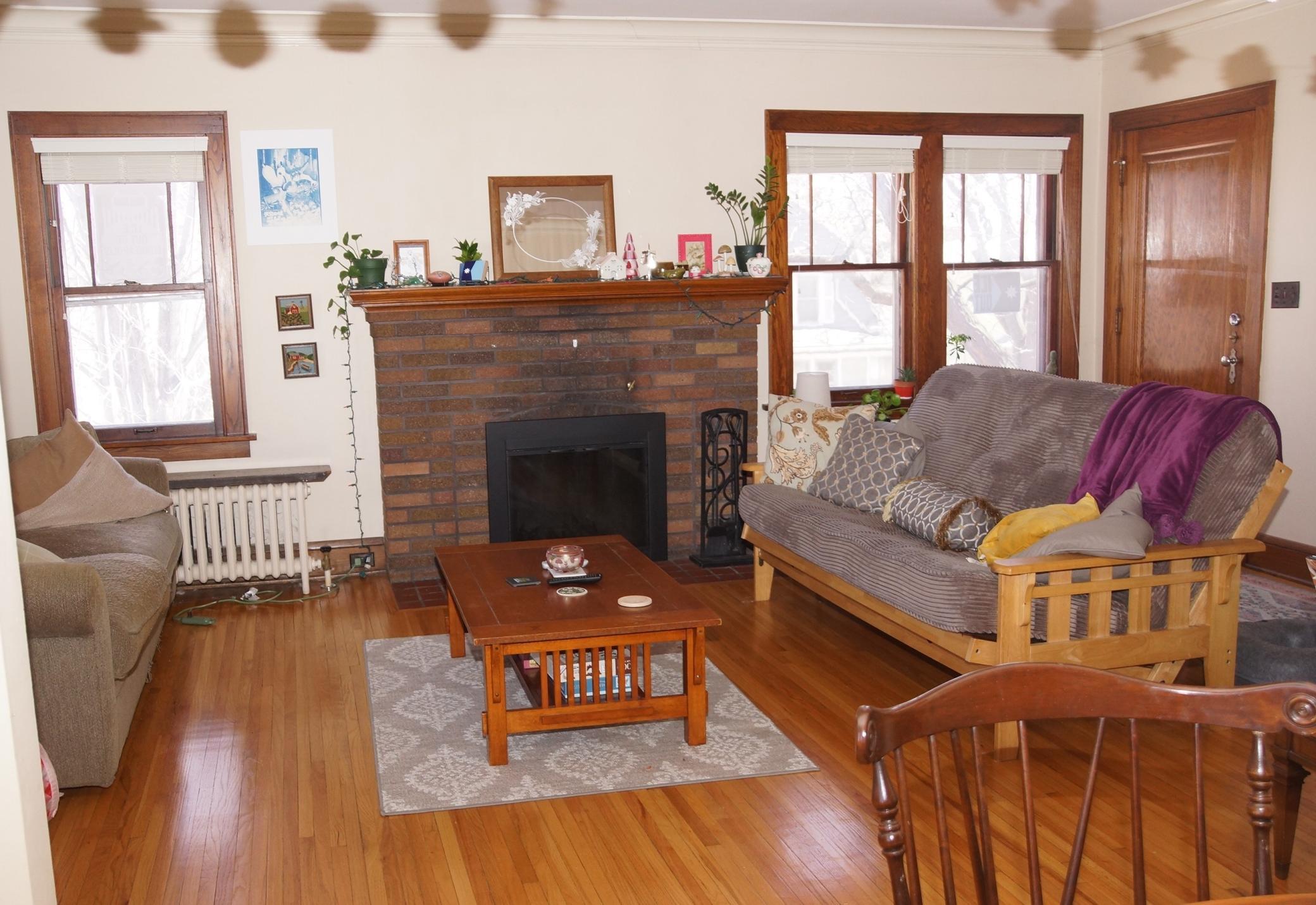 Living room with Hardwood floors, Classic Woodwork and Wood burning fireplace!