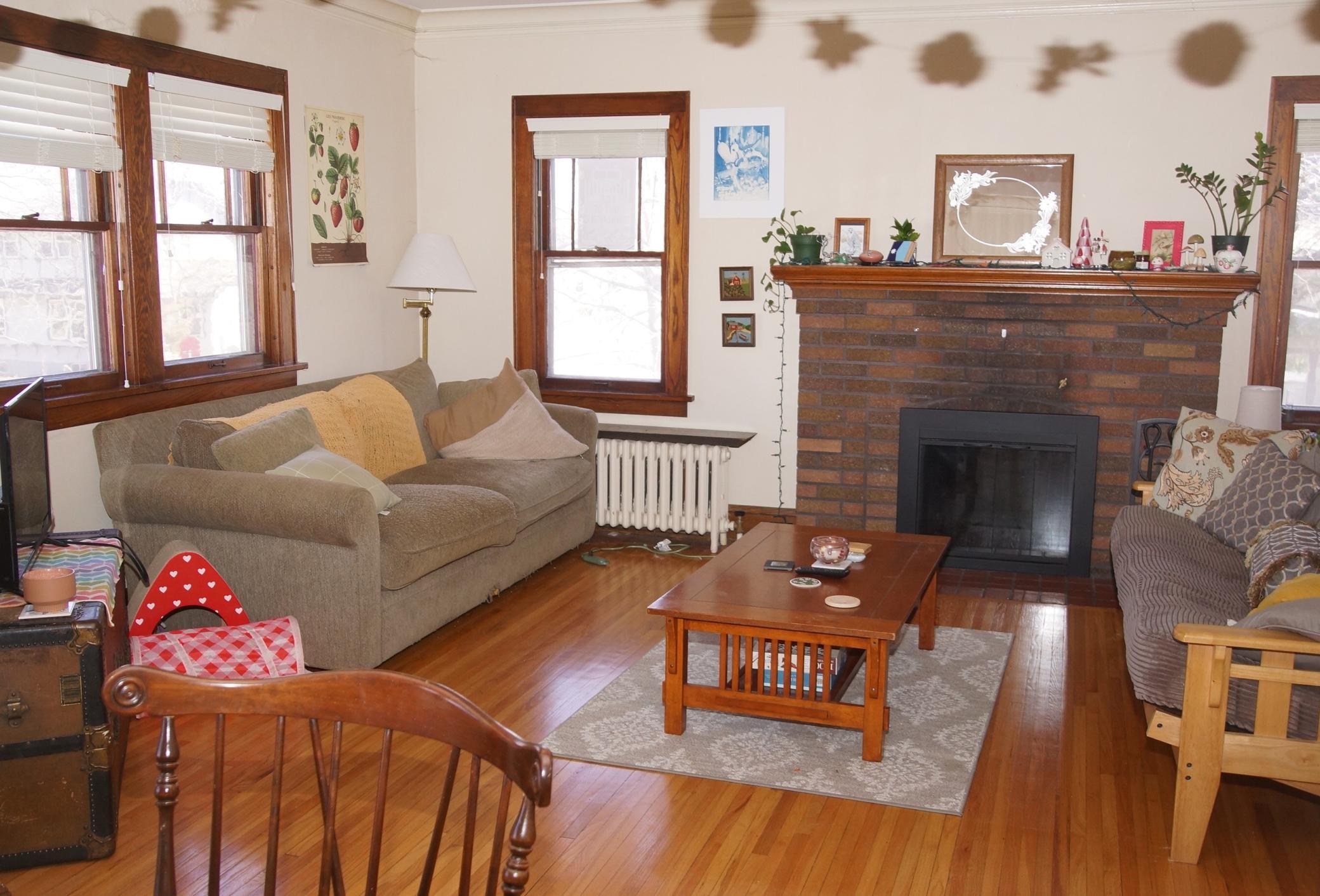 Living room with Hardwood floors, Classic Woodwork and Wood burning fireplace!
